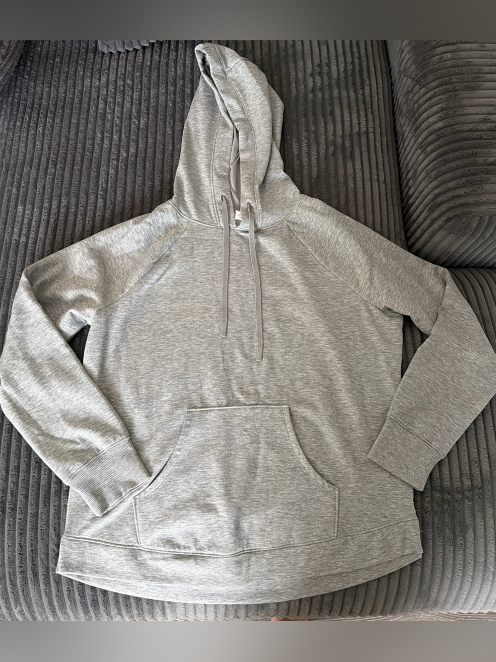 Gray hoodie with drawstring hood and front pocket.